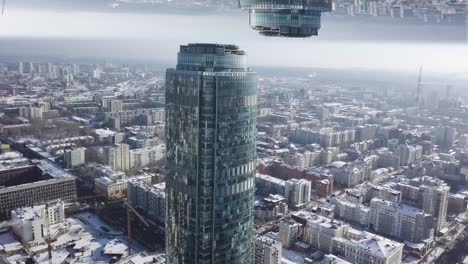 aerial view of a city with a skyscraper and reflection