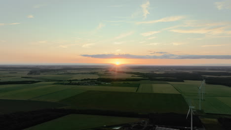Sunset over Farmland with Wind Turbines