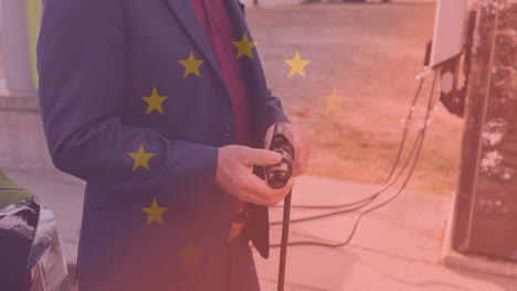 bandera de la unión europea sobre el hombre que conduce un coche eléctrico