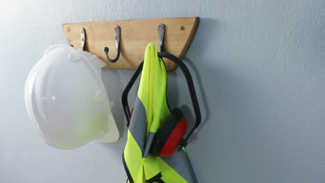 protective workwear hanging on hook 4k