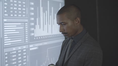 focused black financial broker analyzing trading statistics