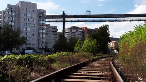 Romanian girl walks on the industrial railway in Resita, Romania