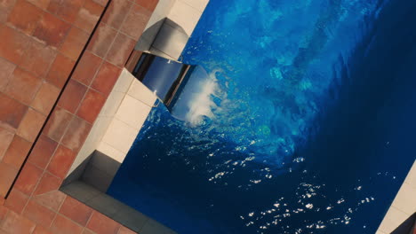 water flowing out from a luxury hydro-massage swimming pool steel fountain