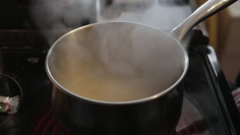 mixing a hot soup in a pan - close up shot