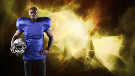 american football player holding helmet over light trails