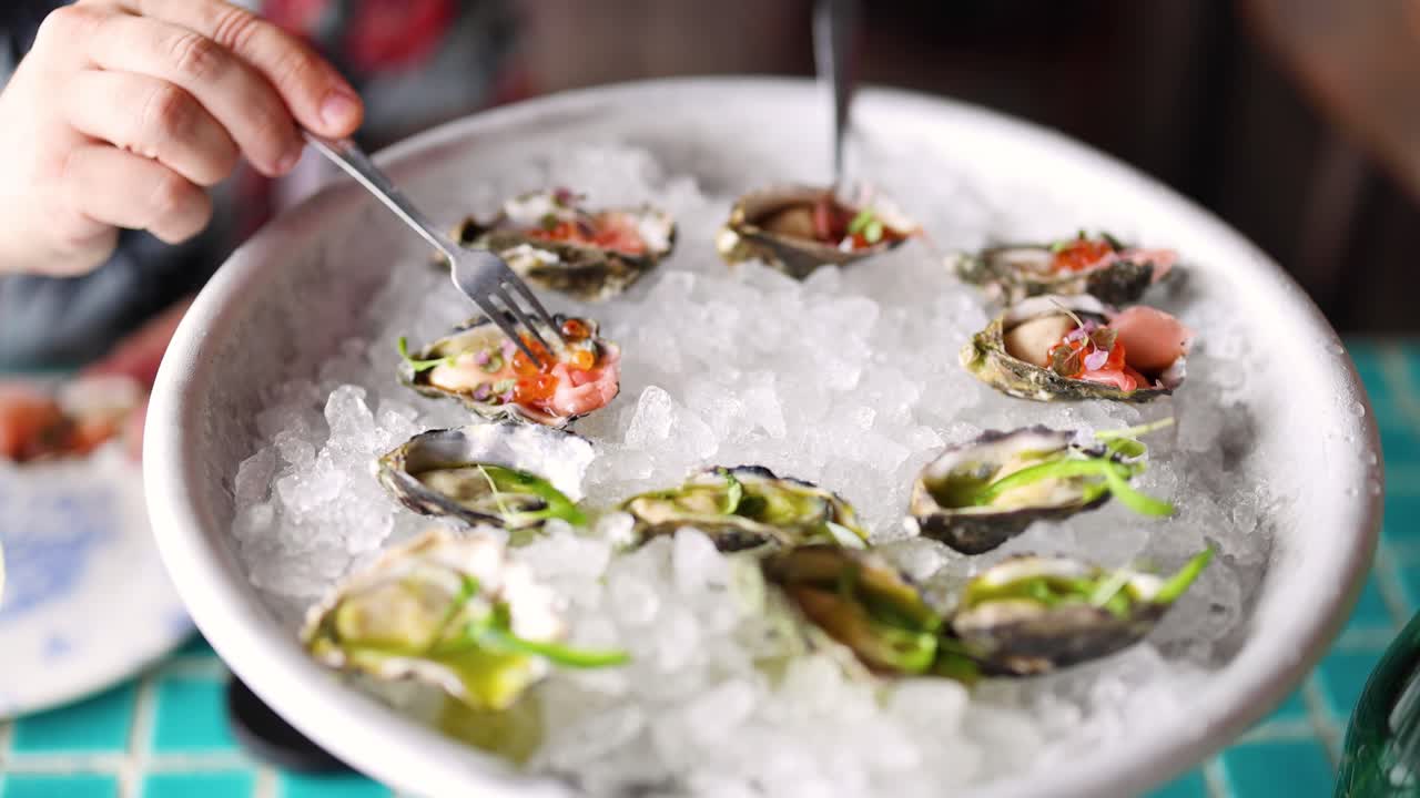 Sequence of presenting a platter of fresh oysters
