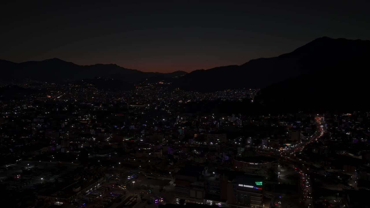 Aerial night footage of Kathmandu city during Diwali (Tihar), featuring the illuminated Dharahara Tower and glowing skyline filled with festive lights, showing Nepal’s vibrant cultural celebration