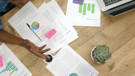 Overhead-View-Colleagues-Working-Together-At-Desk