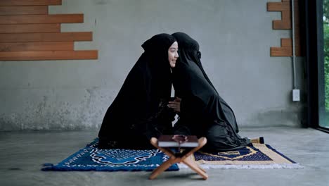 young muslim woman greeting her sister with smile