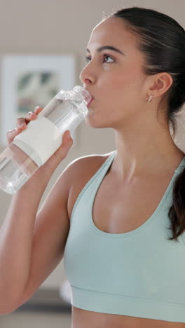 woman drinking water after a workout