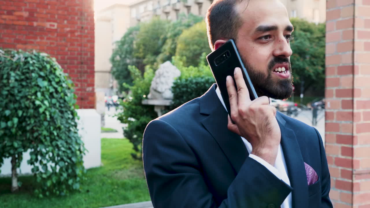 Man in Suit Talking on Mobile Phone Outdoors