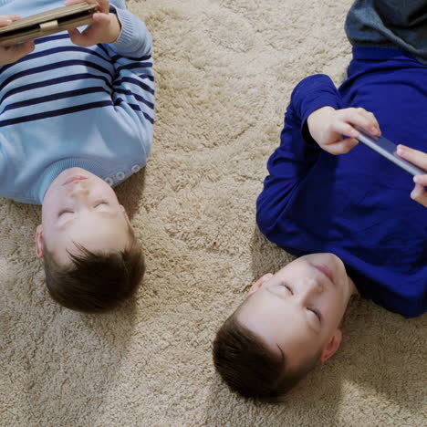 little boys playing game on mobile together. child playing video game at home