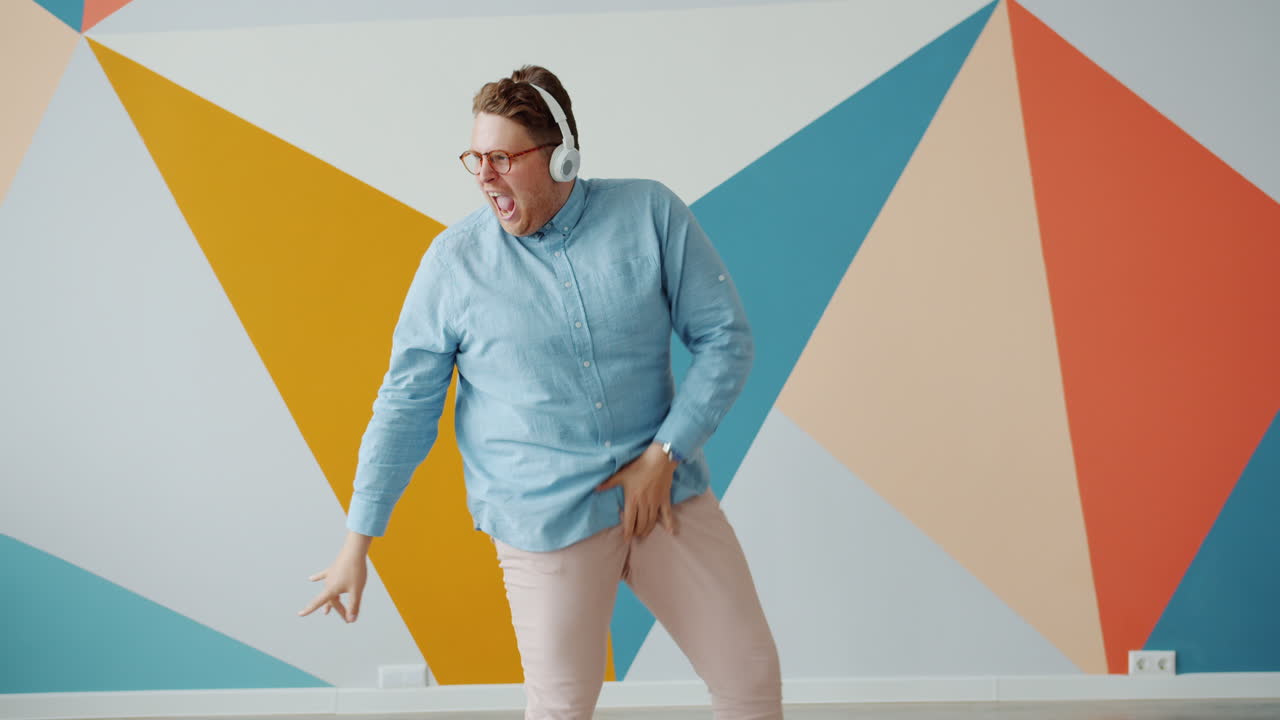 Man Dancing to Music in a Colorful Room