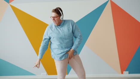 man dancing to music in a colorful room