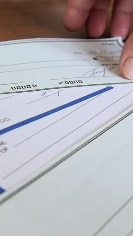 close-up of human hand filling check