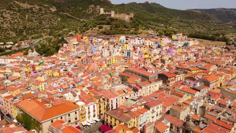 Aerial-view-of-Bosa-town,-colorful-houses-in-Sardinia,-bird's-view,-day