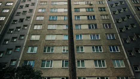 Low-angle-POV-footage-of-a-layered-concrete-prefab-Soviet-era-high-rise-apartment-building