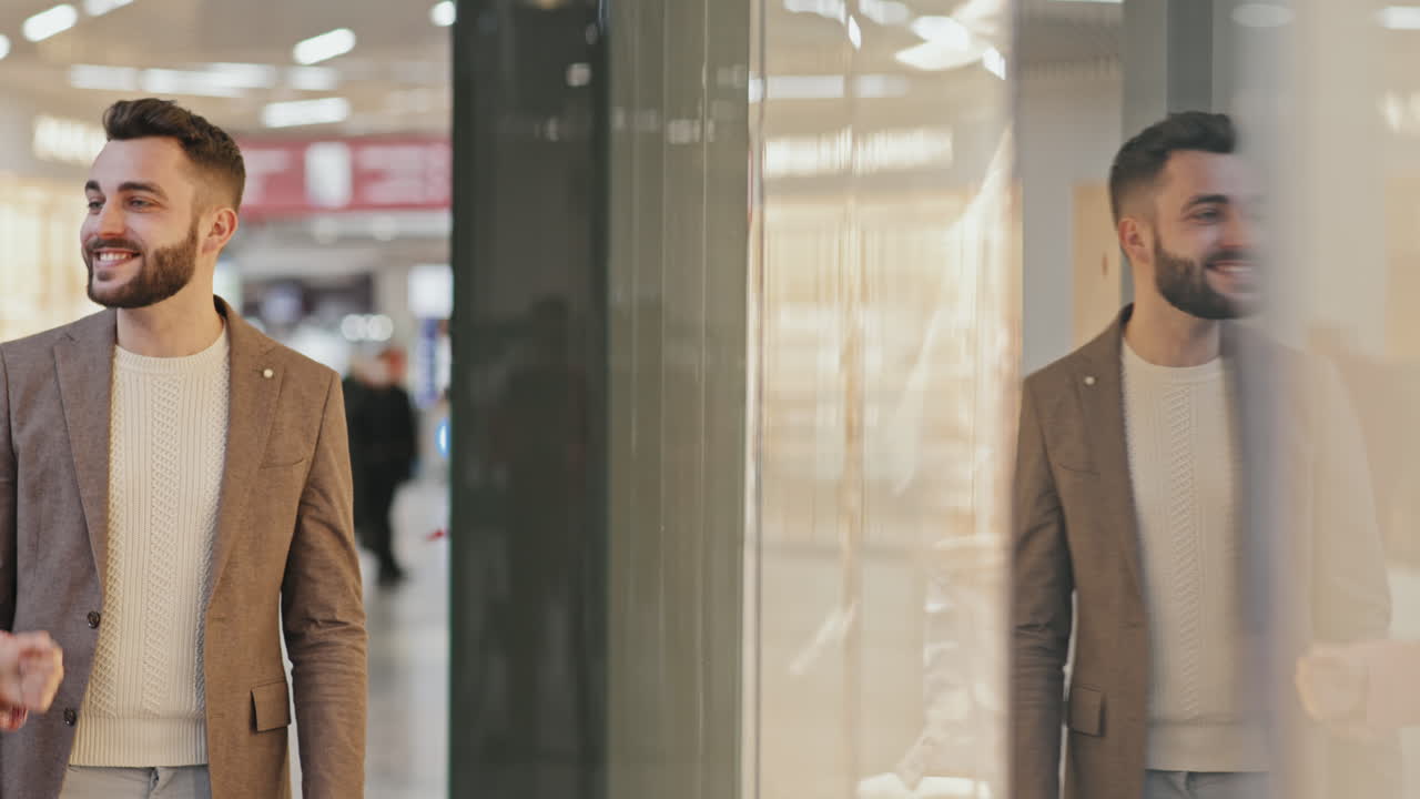 Beautiful Couple Looking At Window Display In Shopping Mall