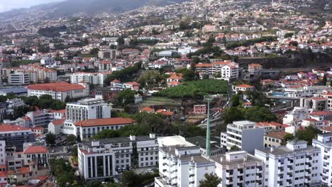 aerial: cable car in city by the ocean in madeira portugal