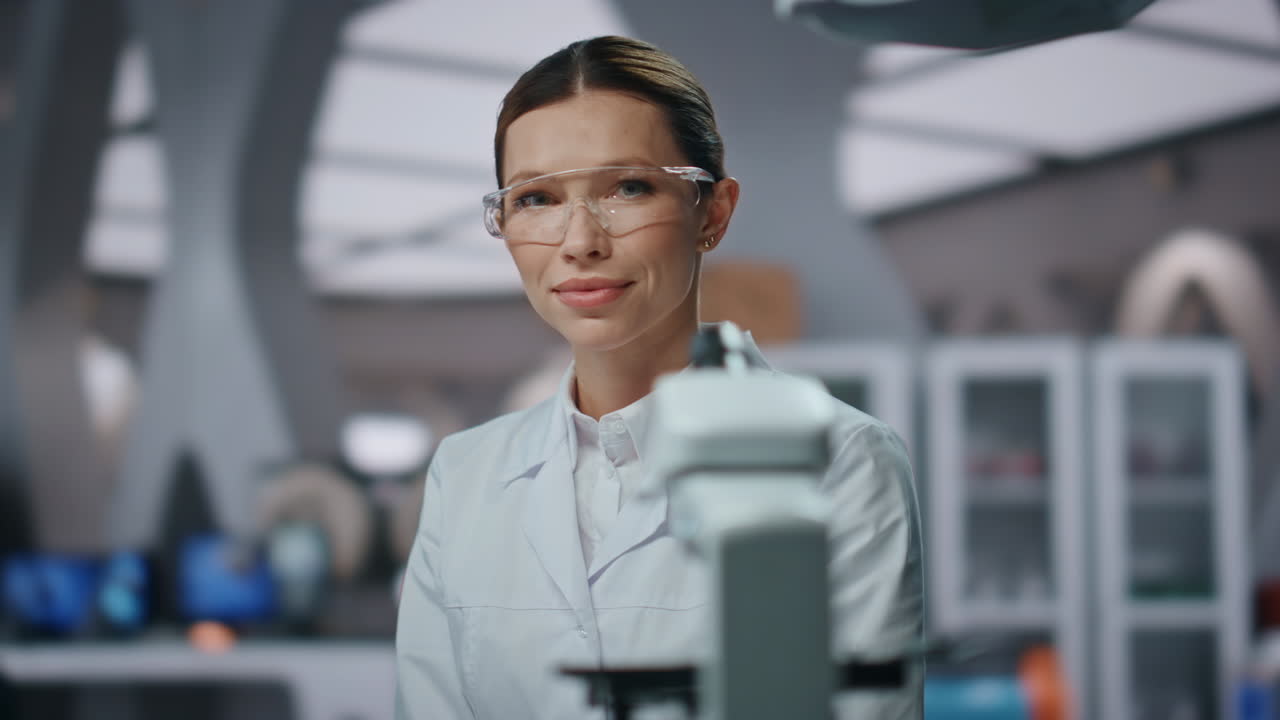 Professional biochemistry researcher looking camera in laboratory close up.