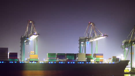 loading a container ship at night, zoom in ease