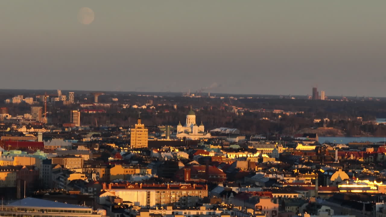 Aerial view around the cathedral and the city, sunset with the moon in Helsinki