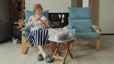 elderly woman knitting at home