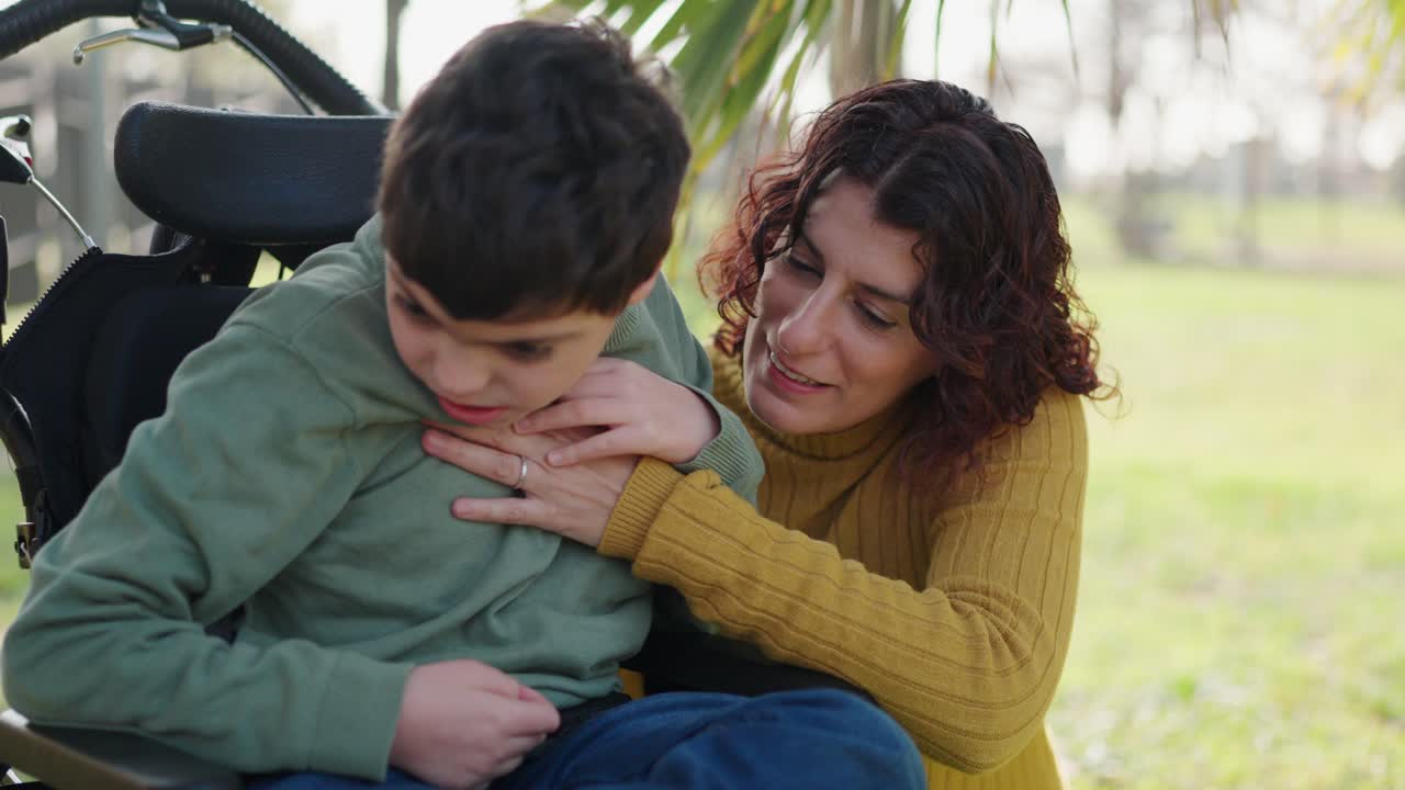 A mother caring for her disabled child in a wheelchair outdoors