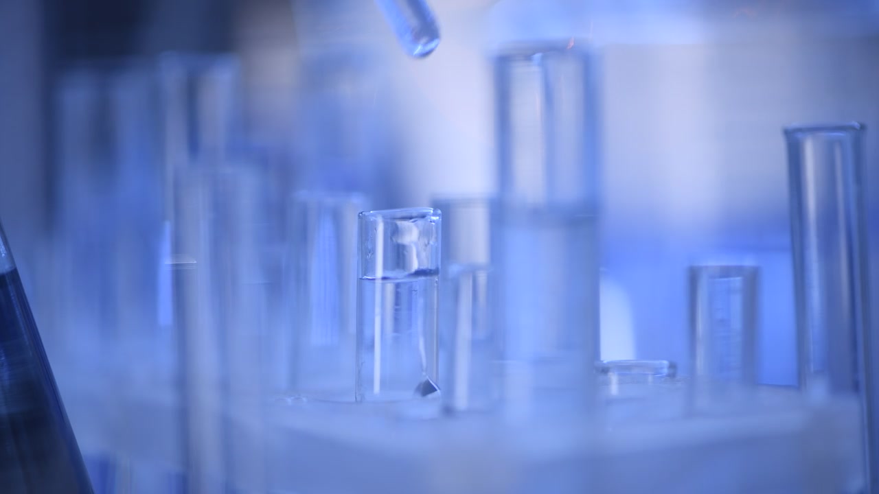Pipette Dropping Liquid into a Test Tube in a Laboratory