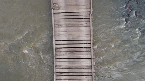 drone captures bridge over flowing river scenery