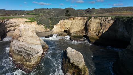 Aerial-view-of-waves-crashing-on-shore-Daven-Port-Shark-Fin-Cove,-Highway-1-California