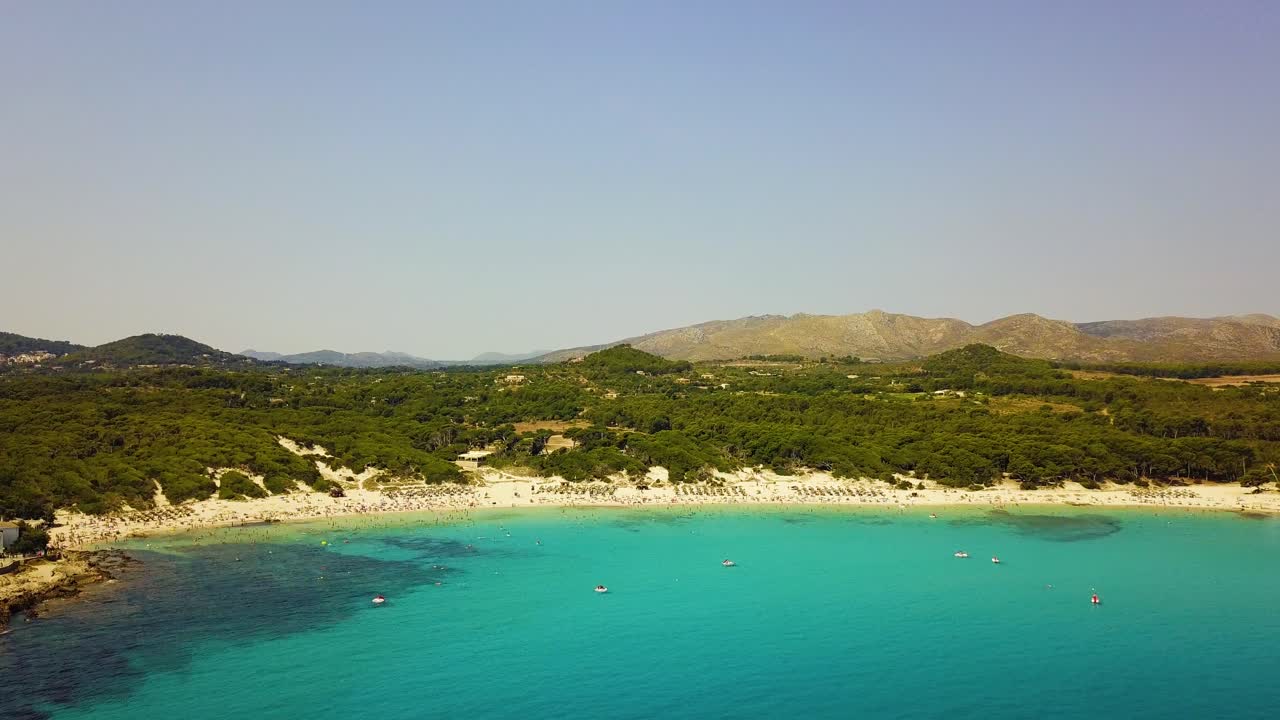 Drone slowly descending to show the expanse of Cala Agulla beachfront, on the island of Mallorca in the Mediterranean Sea