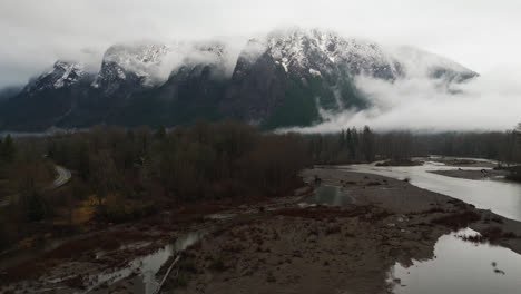 4k drone footage forward video of foggy snowcapped mount si during winter