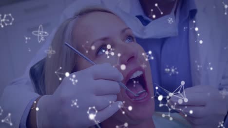 Glowing-molecular-structures-moving-against-dentist-treating-female-patients