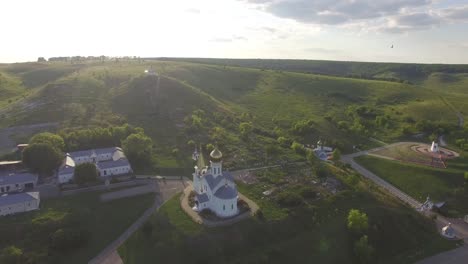 white temple with domes in the mountains in summer