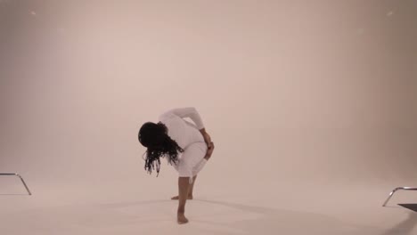 black yogini moves from a traditional triangle pose to bound triangle pose