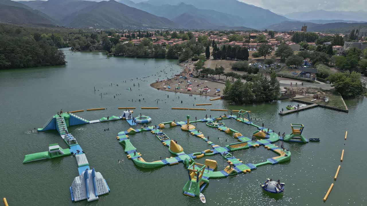 Aerial View of Lake with Beach and Inflatable Water Park