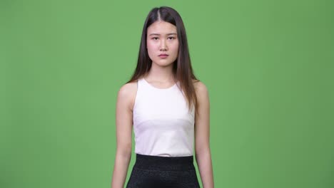 young beautiful asian businesswoman pointing to camera