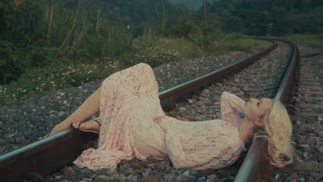 woman in a lace dress on train tracks