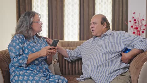 Old-Indian-man-surprising-his-wife-with-a-gift