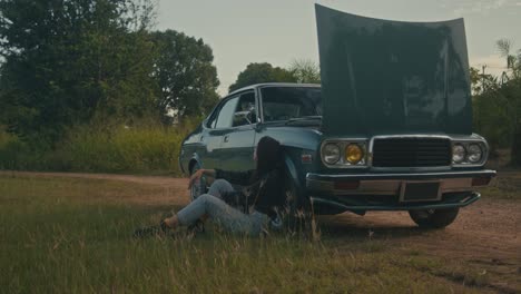 woman with broken down vintage car