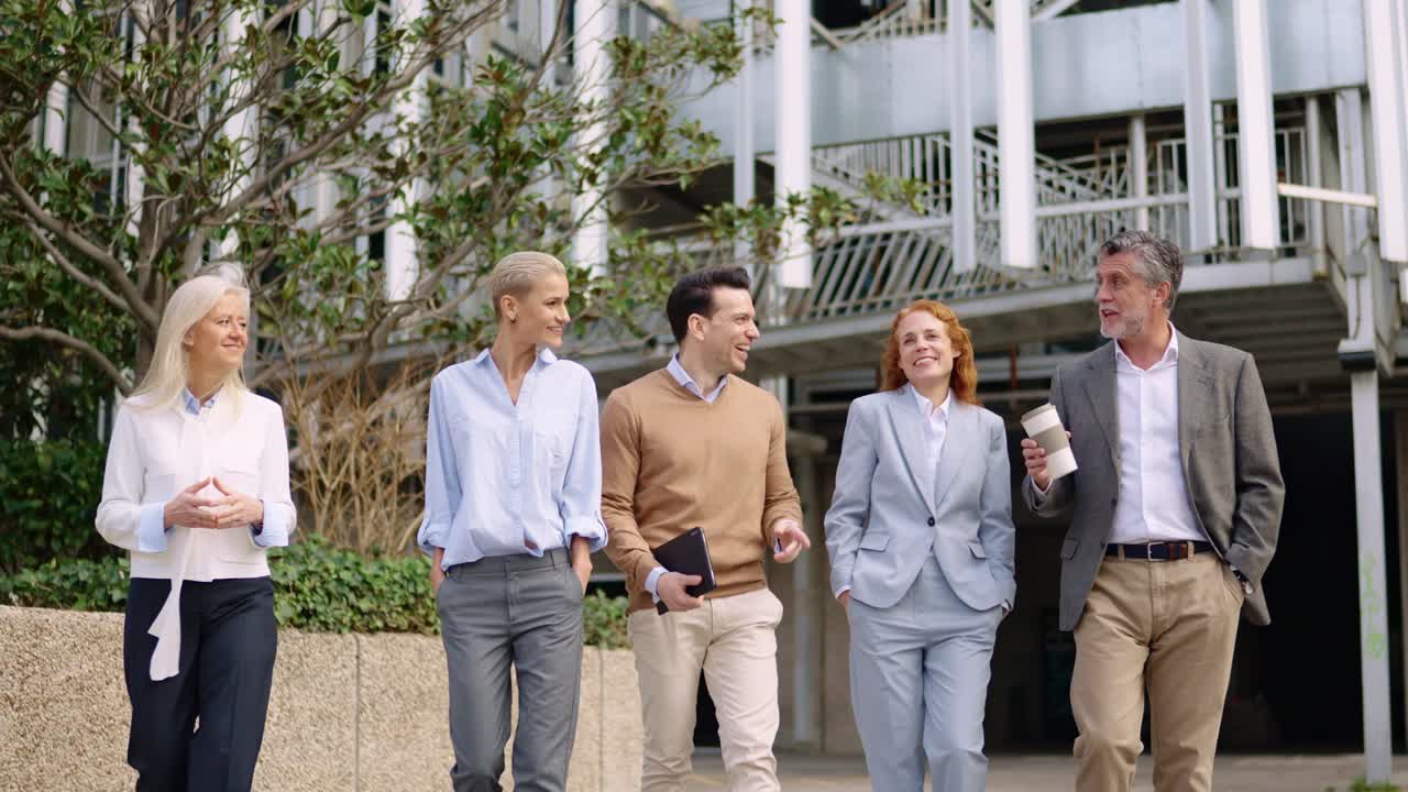 Business team walking and collaborating outdoors