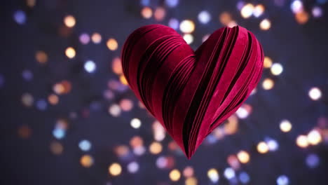 red textured heart with bokeh lights background