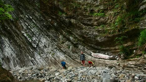 people exploring a rocky canyon