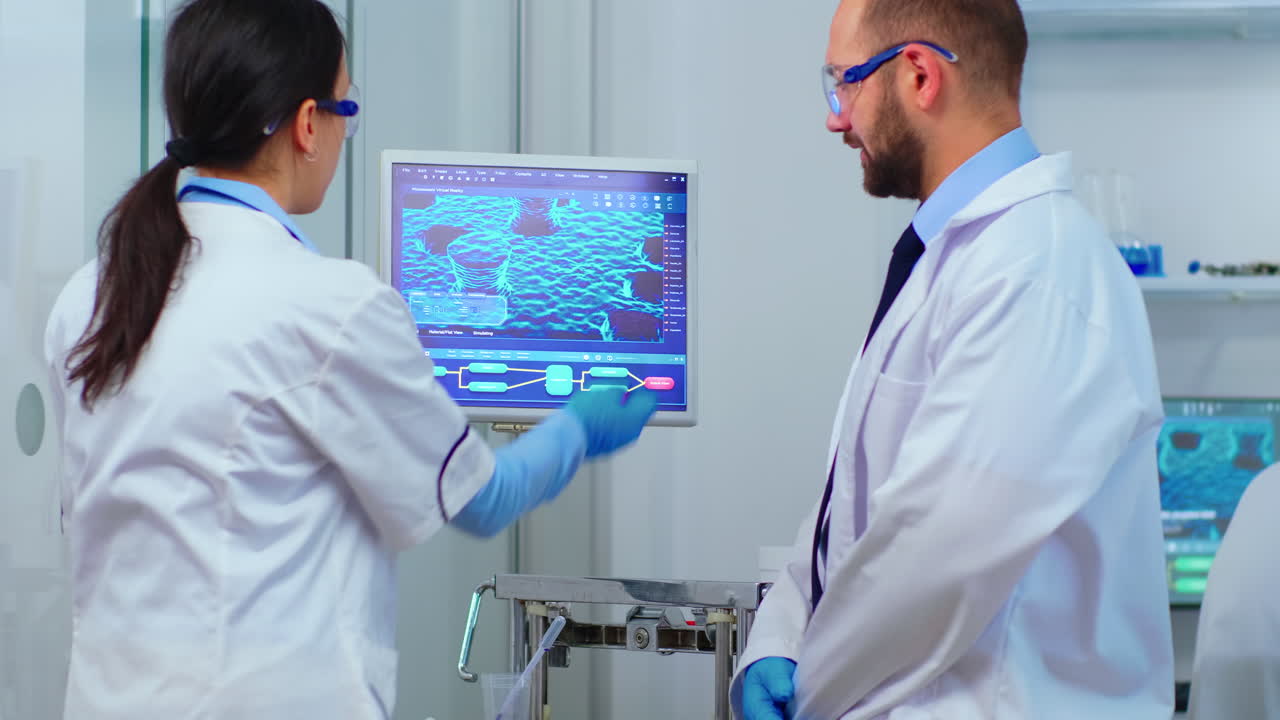 Scientist team arguing in front of computer looking at virus development