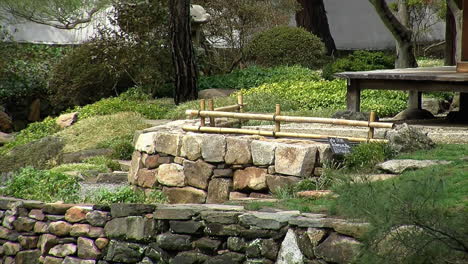 stone retaining walls and bamboo fence in a japanese garden