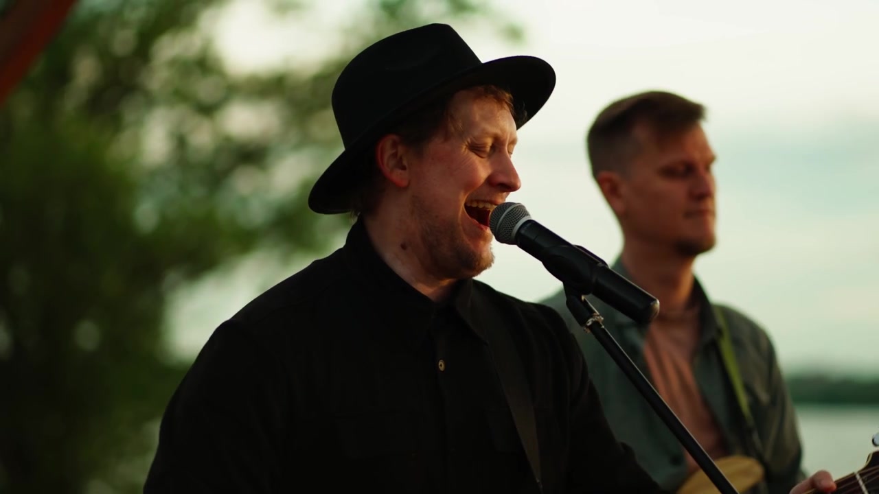 Musikband optræder live udendørs ved solnedgang