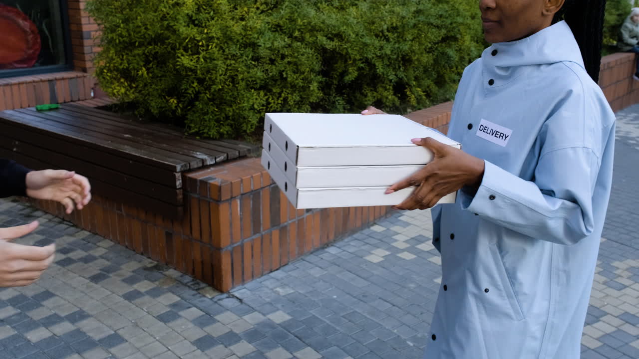 Delivery woman holding carton boxes