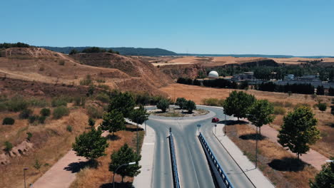 aerial view of a country road roundabout and surrounding landscape