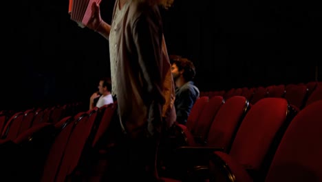 Woman-having-popcorn-and-cold-drink-while-watching-movie-4k